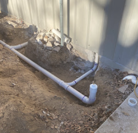 Underground drain and sewer pipe trench installation